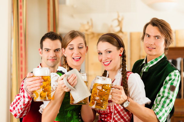 people in traditional Bavarian Tracht in restaurant or pub - Photo, Image