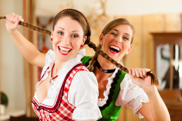 women in traditional Bavarian Tracht in restaurant or pub - Foto, afbeelding
