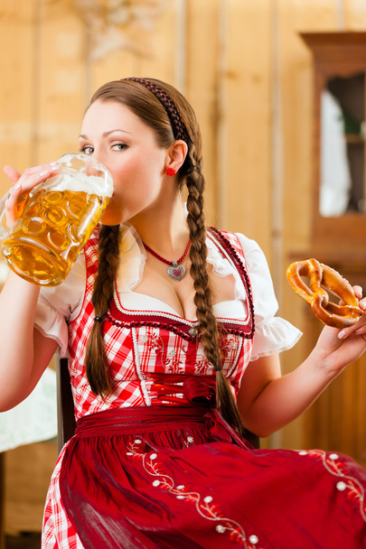 woman in traditional Bavarian Tracht in restaurant or pub - Photo, image