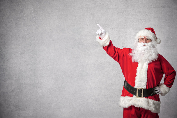 Santa Claus pointing on a wall - Photo, image