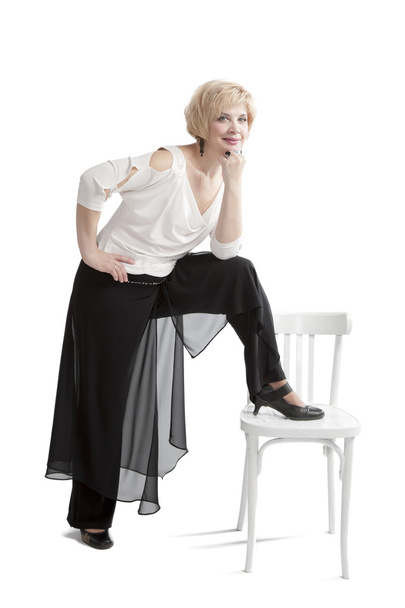 Woman posing beside the chair - 写真・画像