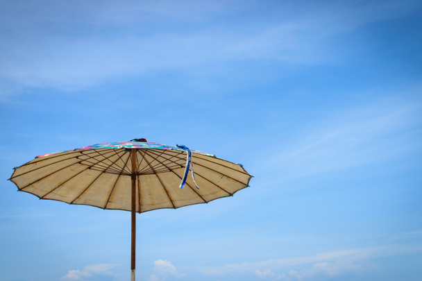 Beach umbrellas on blue sky background - Photo, Image