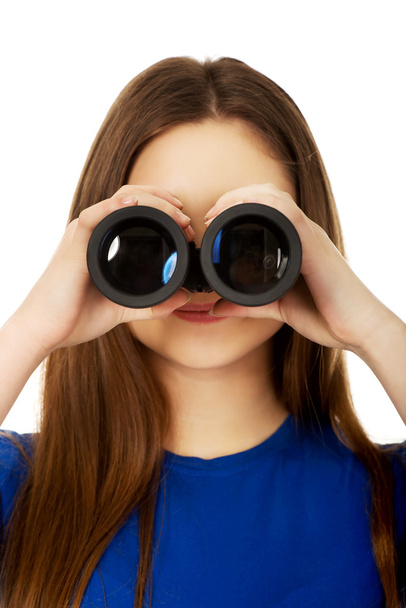 Young woman with binoculars. - Valokuva, kuva