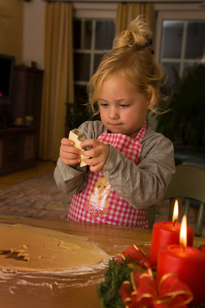 Child at christmas in advent when baking cookies - Foto, Imagem