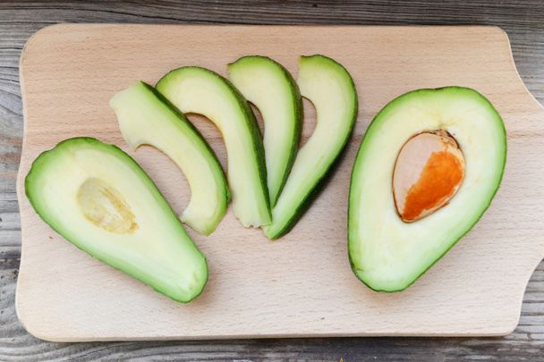 Healthy green avocado on wooden table - Photo, Image
