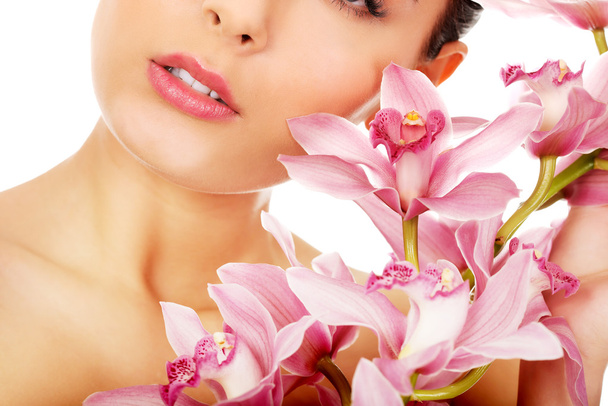 Beautiful woman with pink flower. - Fotografie, Obrázek