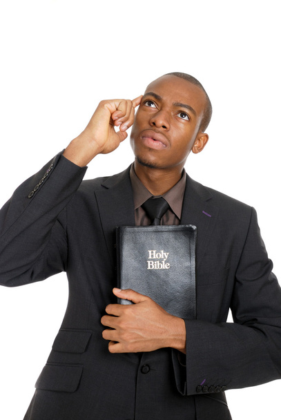 Mann hält Bibel während er denkt - Foto, Bild