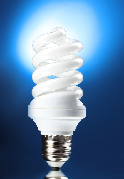 Energy saving lamp on blue background - Photo, Image