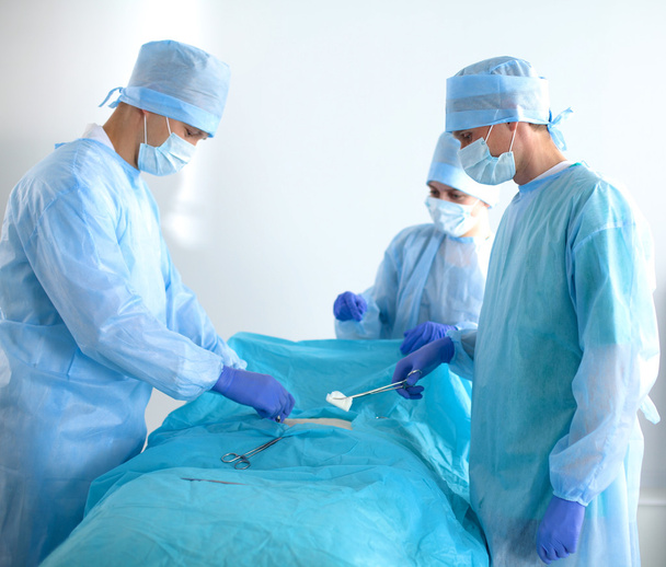Team of surgeon in uniform perform operation on a patient at cardiac surgery clinic - Foto, imagen