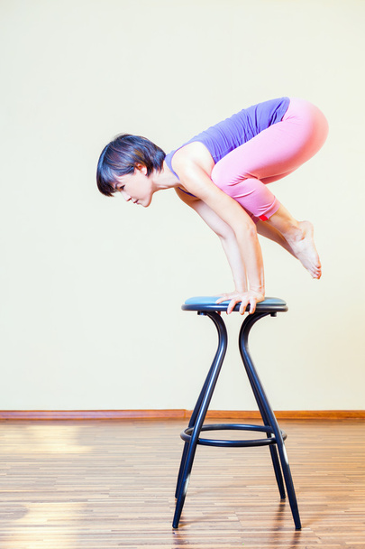 Asian woman doing exercise or yoga at home at chair - Φωτογραφία, εικόνα