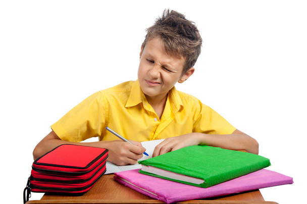 Boy with books makes a grimace. All on white background. - Photo, Image