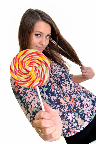 Sexy young brunette woman with a lollipop - Fotó, kép
