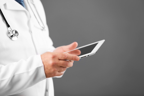 Doctor with digital tablet on colorful background - Fotografie, Obrázek