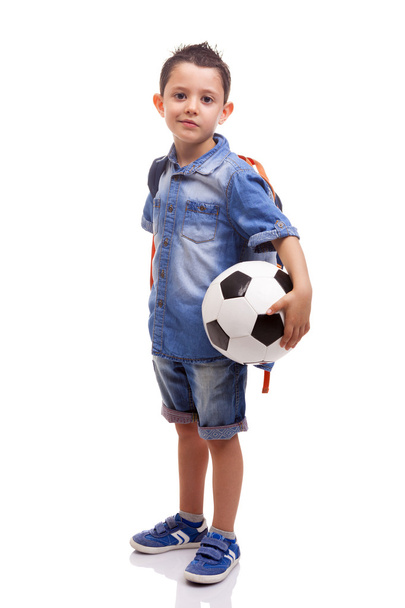 School boy standing with a soccer ball and backpack - Foto, imagen