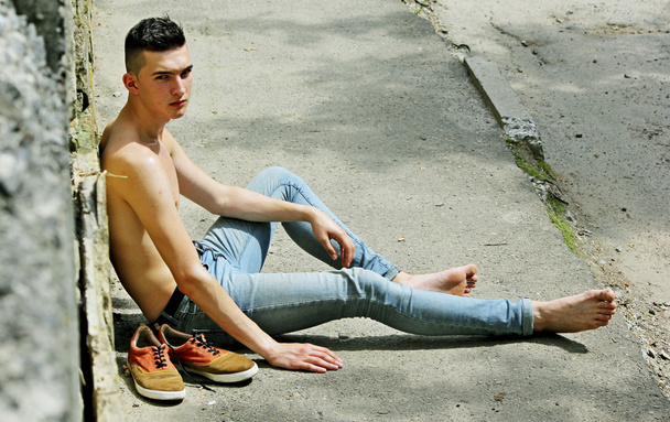 Young trendy guy in jeans amid nature. - Foto, imagen