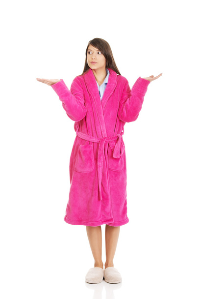 Woman in pink bathrobe showing empty palms. - Zdjęcie, obraz