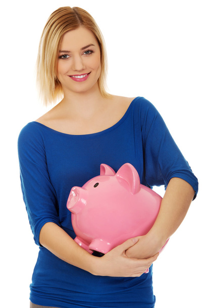 Happy woman holding piggybank. - Foto, Imagen