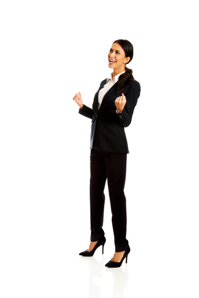Cheerful businesswoman in a winner gesture - Фото, зображення