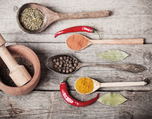 Colorful spices on a wooden background - Valokuva, kuva