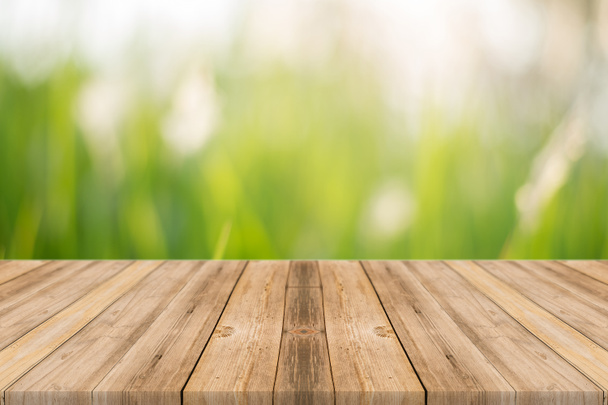 Wooden board empty table blur trees in forest - can be used for display or montage your products. spring season. vintage filtered image. - Photo, Image