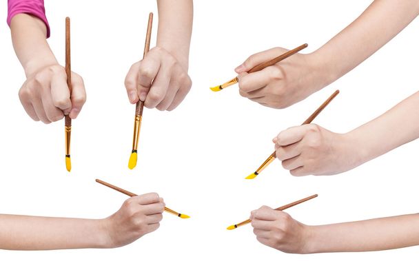 set of hands with art paintbrushes with yellow tip - Photo, Image