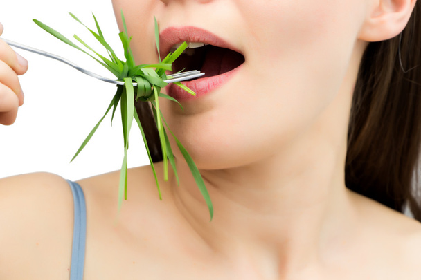 Woman with fork and wheatgrass, isolated on white. - Photo, image