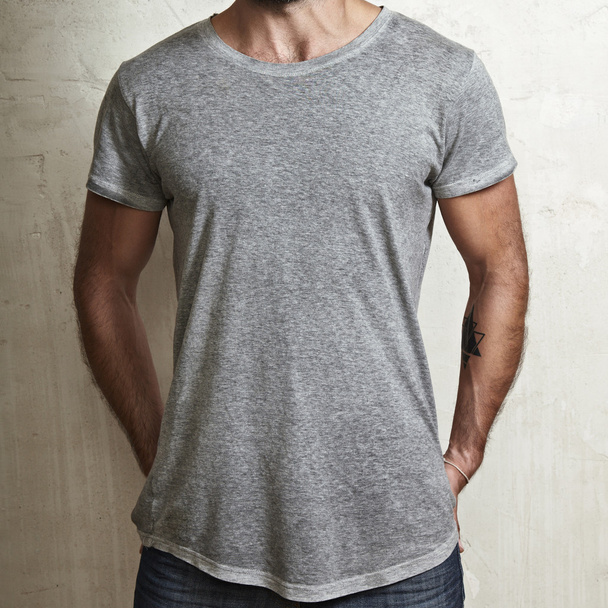 Muscular guy wearing grey t-shirt - 写真・画像