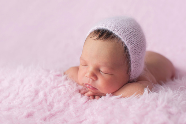 Newborn Baby Girl Wearing a Pink Knitted Bonnet - Photo, Image