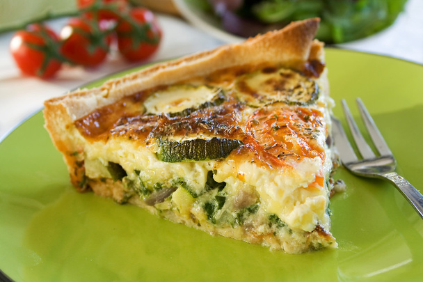 A sliced portion of Zucchini quiche on a plate - Foto, Imagen