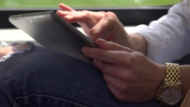 young attractive blonde woman traveling by train and works on tablet - closeup - Video