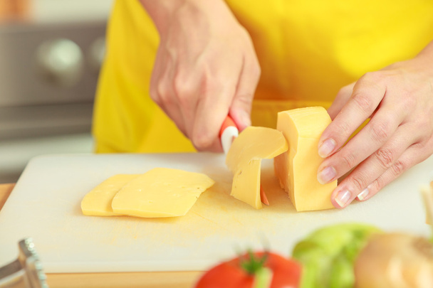 Woman cutting pieces of cheese - Foto, Imagem