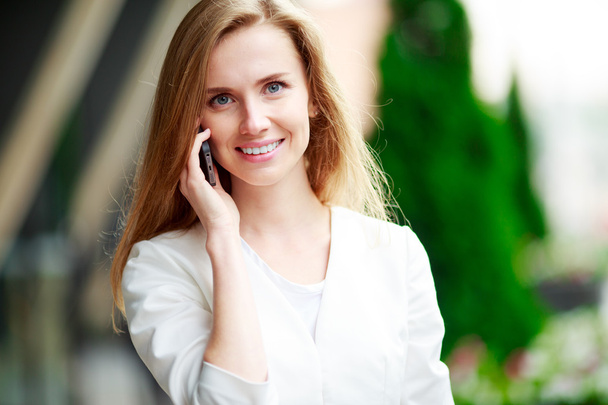 Young beautiful smiling woman talking on cell phone - Zdjęcie, obraz