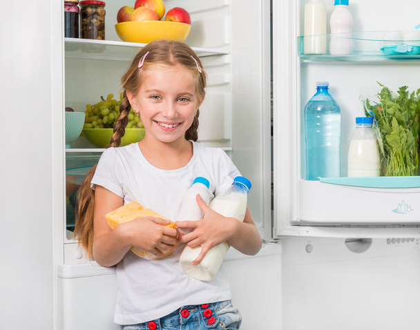 little girl holding cheese and milk - Fotó, kép
