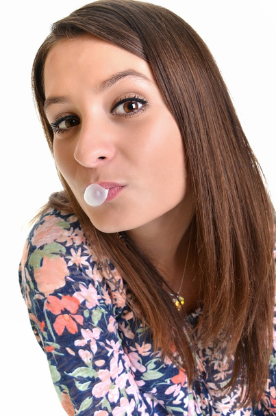 Beautiful girl making a bubble from chewing gum - Valokuva, kuva