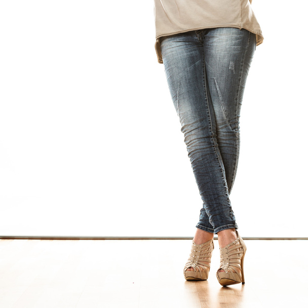 Woman in denim trousers standing - Fotó, kép