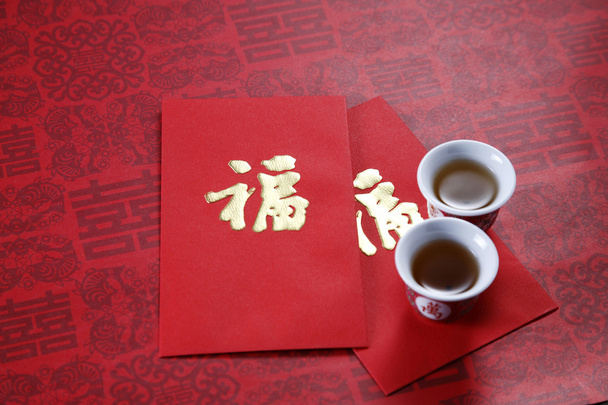 Tea cup and red packet - 写真・画像