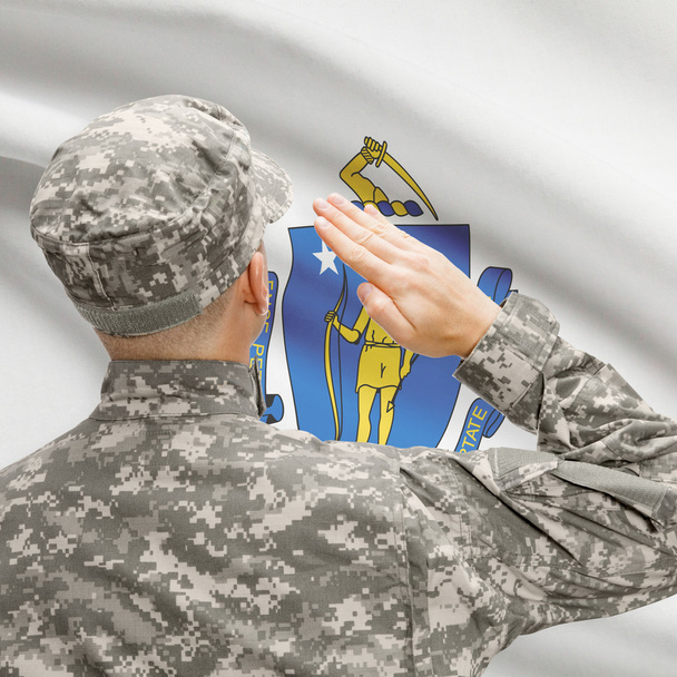 Солдат, салютование нам государства флага серии - Массачусетс - Фото, изображение