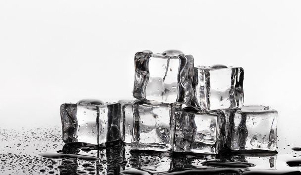 Melting ice cubes isolated on white - 写真・画像