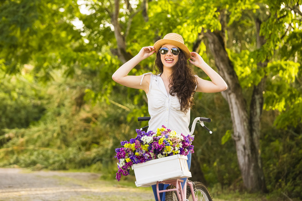 Happy girl with her bicycle - Фото, зображення