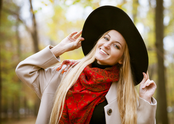 Fashionable blond woman at beautiful autumn alley  - Photo, Image