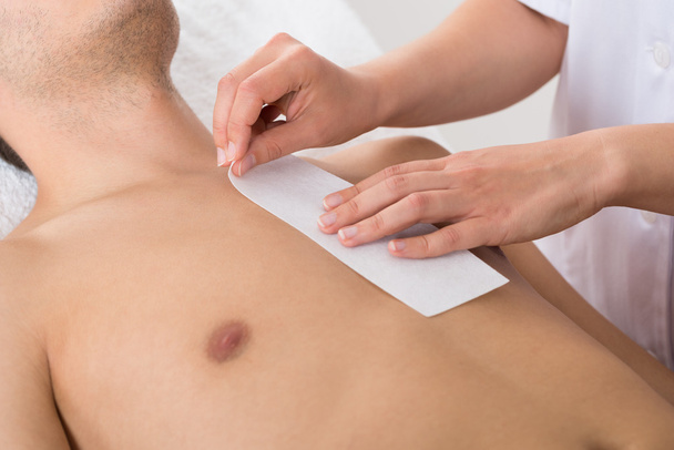 Person Hands Waxing Man's Chest - Photo, image