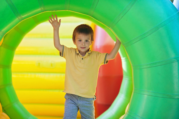 Cute little boy, playing in a rolling plastic cylinder ring, ful - Foto, Imagen