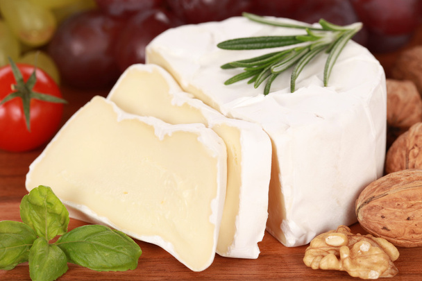 Still life with Camembert cheese cut on slices - Valokuva, kuva