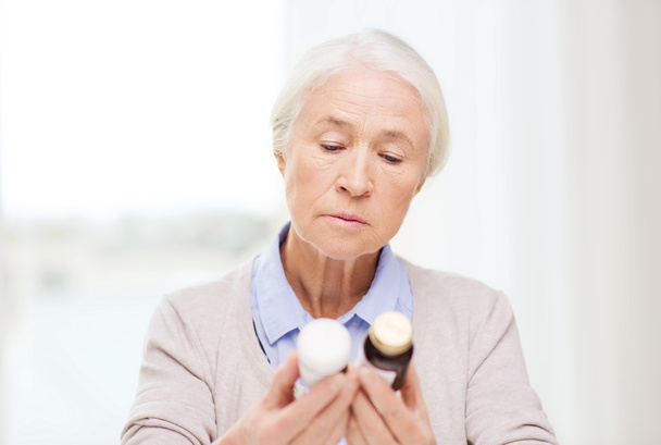 senior woman with medicine jars at home - Photo, Image