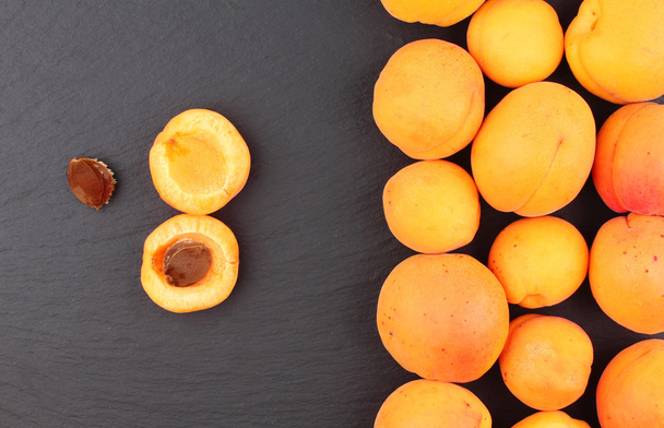 Fresh apricots on line isolated on blackboard - Photo, Image
