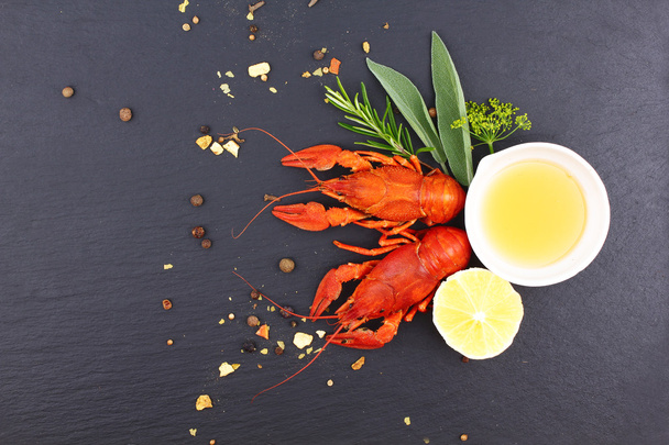 Delicious fresh lobster on dark vintage background. Seafood with aromatic herbs, spices and vegetables - healthy food, diet or cooking concept - Fotografie, Obrázek