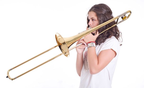 Teenage girl playing the trombone - Fotoğraf, Görsel