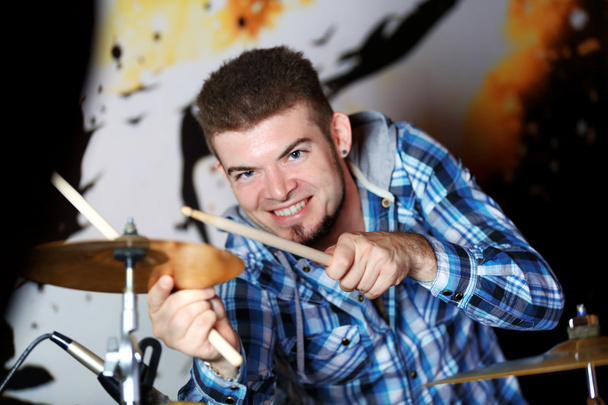Excited drummer on bright background - Foto, imagen