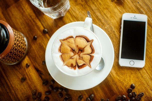 High angle view of smart phone with blank screen and Cappuccino  - Фото, зображення