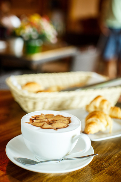 Cappuccino and croissants on a brown background - Fotografie, Obrázek